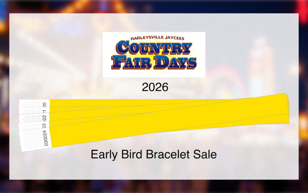 Country fair logo with bracelets and a few fair rides with lights on in a blurry background
